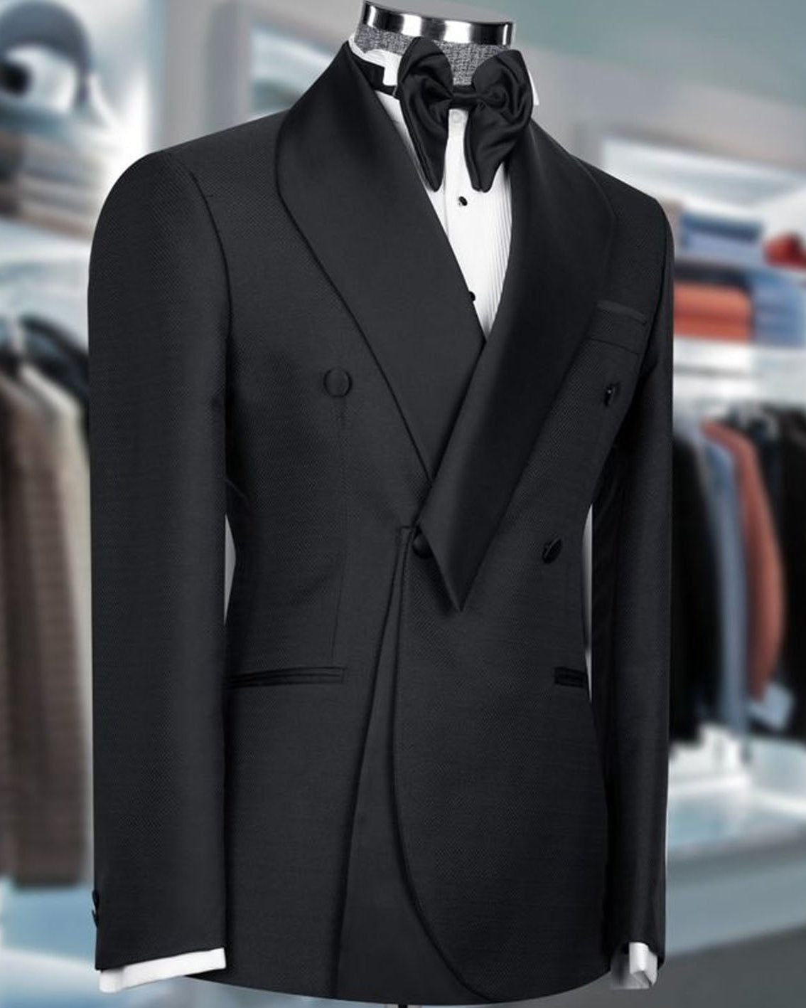 Black tuxedo on a mannequin with a blurred clothing store background