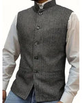 Gray vest worn over a white shirt on a white background