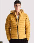 Man wearing a mustard yellow puffer jacket on a light gray background