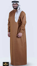 Man wearing a brown traditional outfit with a white scarf on a white background