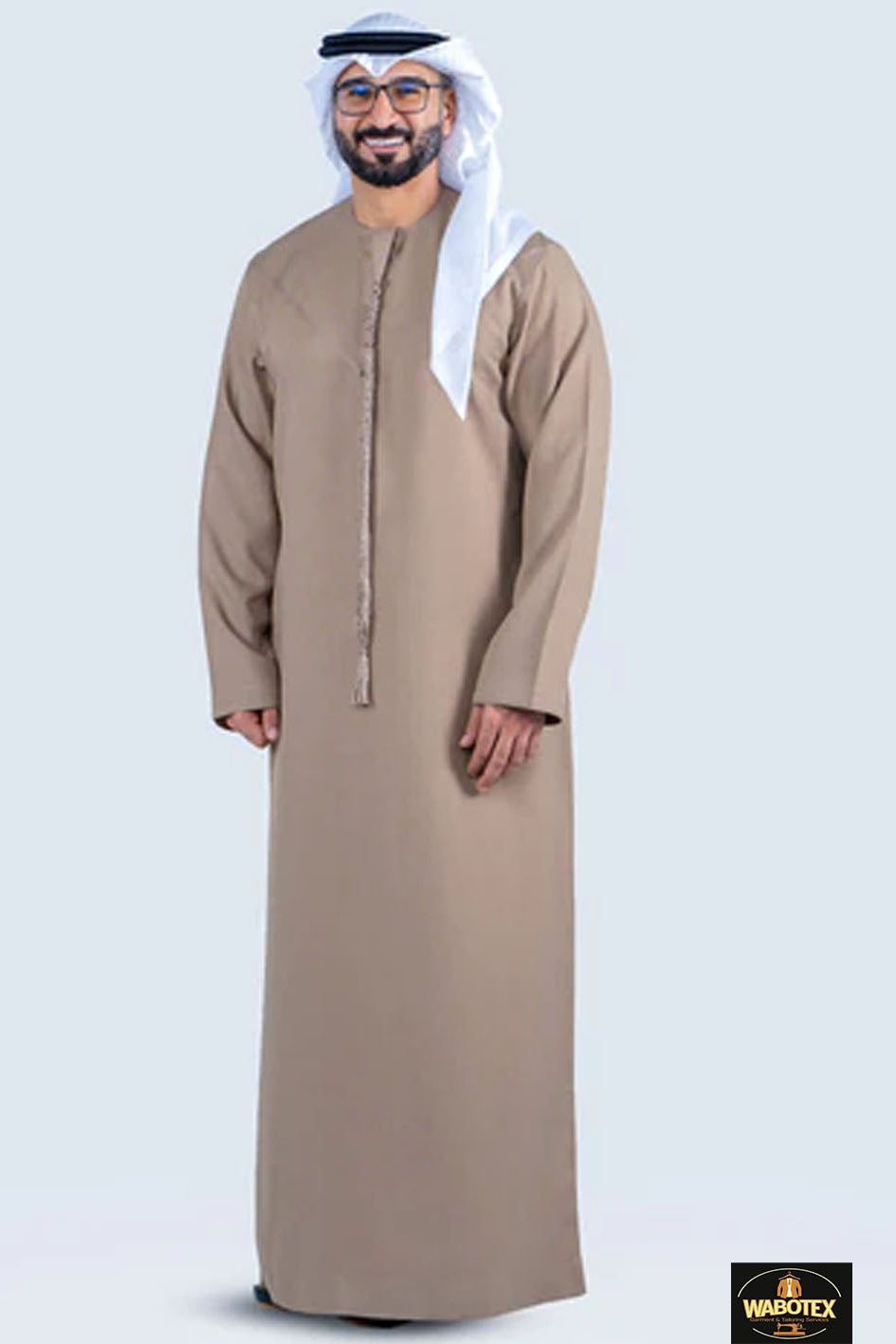 Man wearing a traditional beige thobe with a white headscarf on a light gray background